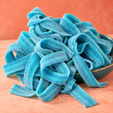 Blue Raspberry Sour Belts in a bowl, chewy bright blue sour candy strips coated in sour sugar