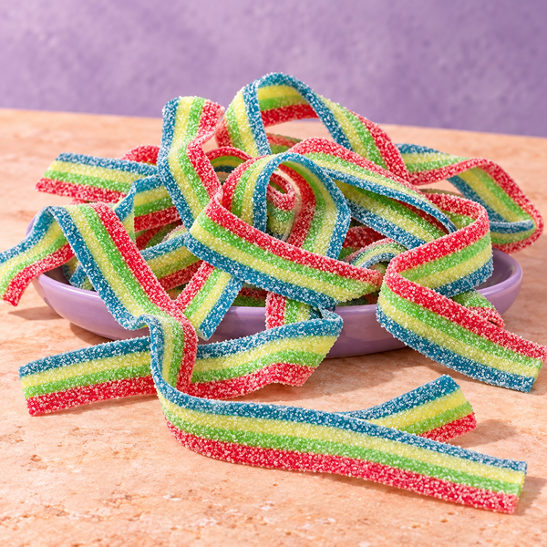 Rainbow Sour Belts in a bowl, chewy rainbow-striped sour candy strips coated in sour sugar