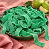 Pile of green apple sour candy belts for parties and candy buffets