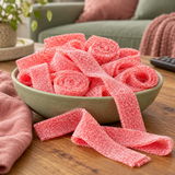 Close-up of Strawberry Sour Belts showing the sour sugar coating on strawberry candy belts