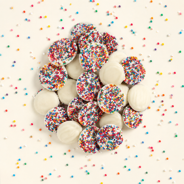 White chocolate nonpareils topped with rainbow seeds